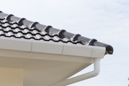 white gutter on the roof top of houseの写真素材