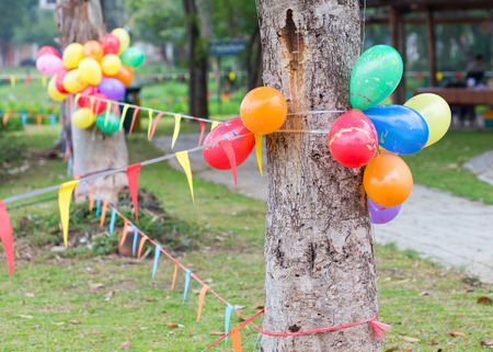 outdoor party in garden decorated with colorful ballons and flagsの写真素材