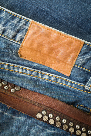 blue jeans with leather belt and label tagの写真素材