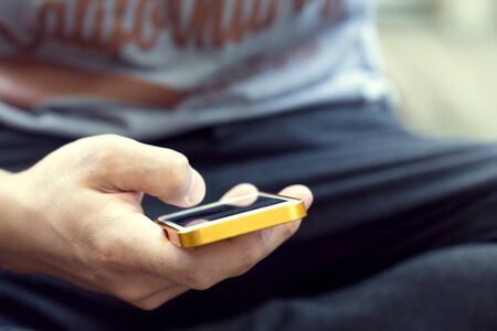 lifestyle young man using a mobile phone with texting message on app smartphone, playing social...