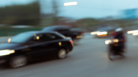 car and motorcycle driving on road with traffic jam in the city, abstract blurred backgroundの写真素材