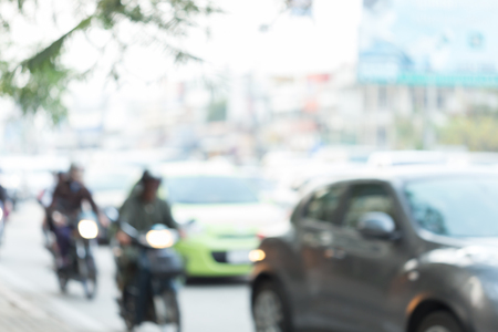 car and motorcycle driving on road with traffic jam in the city, abstract blurred backgroundの写真素材