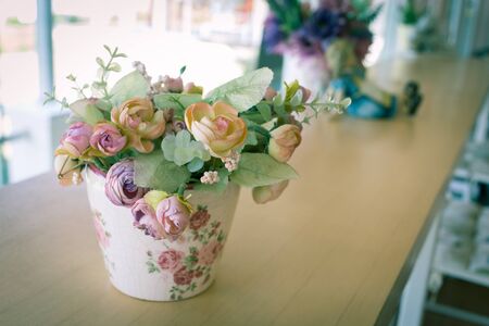 flowers vase decoupage decorated on wooden table at living room, artificial flowers in vaseの写真素材