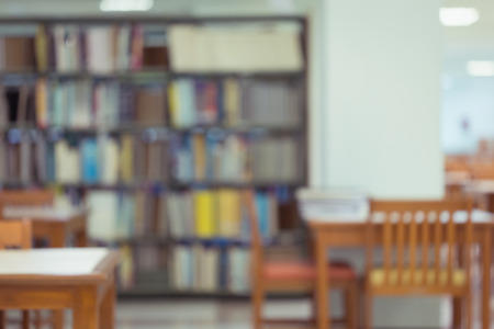 bookshelf and table desk in library, education abstract blur defocused backgroundの写真素材