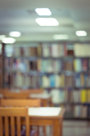 bookshelf and table desk in library, education abstract blur defocused backgroundの写真素材