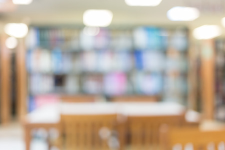 library with table desk and bookshelf, abstract blur defocused backgroundの写真素材