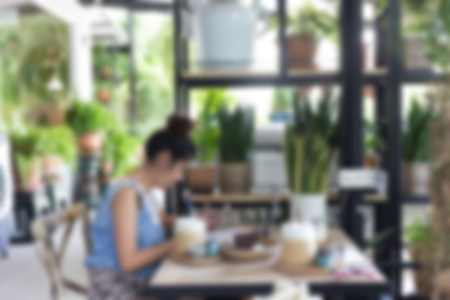 abstract blur image, lifestyle of working woman use a laptop notebook computer in cafe coffee drinkの写真素材
