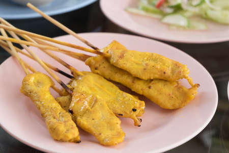 thai food, baked stringed meat on wood stickの写真素材