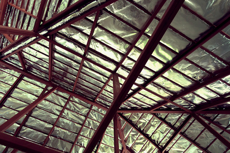 roof with steel beam and silver foil insulation heat on ceiling roof house, image used filter vintageの写真素材