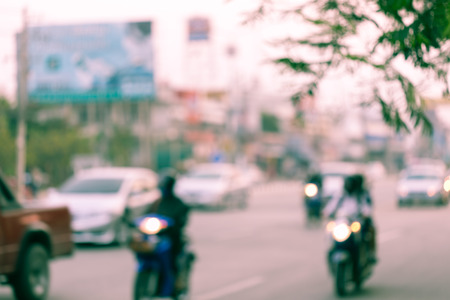 car and motorcycle driving on road with traffic jam in the city, abstract blurred backgroundの写真素材