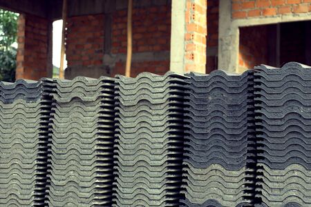 stack of black roof tiles in construction site, image used filter vintageの写真素材