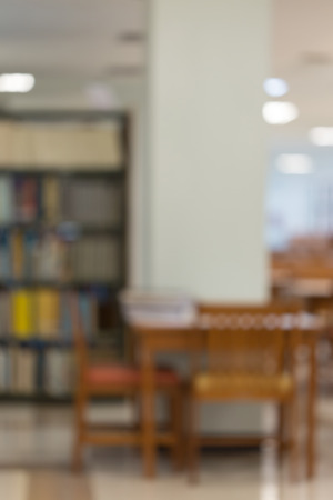 bookshelf and table desk in library, education abstract blur defocused backgroundの写真素材