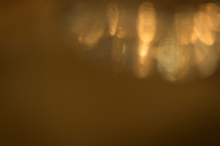 abstract gold light glitter glowing for celebration festive backgroundの写真素材