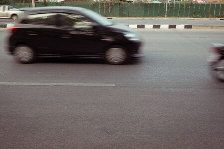 car fast motion blurred driving on roadの写真素材
