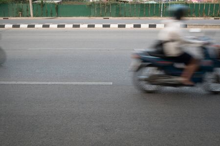 motorcycle fast motion blurred driving on roadの写真素材