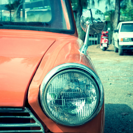 close-up headlight of colourful classic car, image used filter vintageの写真素材