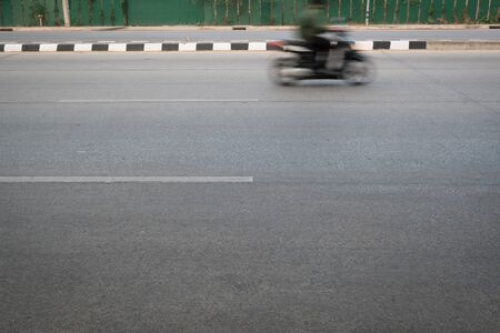 motorcycle fast motion blurred driving on roadの写真素材