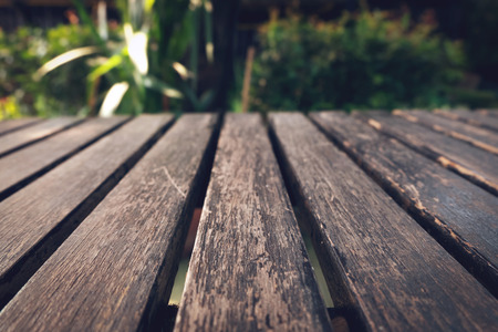 old table wood plank with green natural blurred backgroundの写真素材