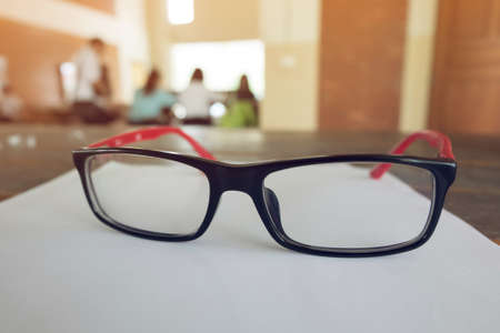 eye glasses placed on a blank paper sheetの写真素材