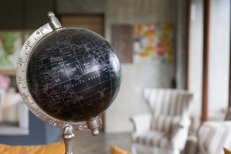 model of black world decorated in living room with furniture backgroundの写真素材