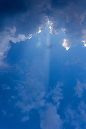 sun beam in blue sky with clouds backgroundの写真素材