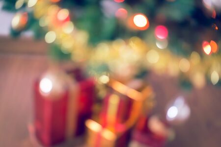 blur light celebration on christmas tree with gift box in living roomの写真素材