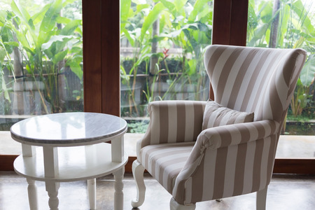 design of interior living room modern style with sofa furniture in green garden backgroundの写真素材