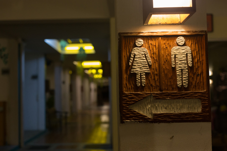wooden toilet signs with icon male and femaleの写真素材
