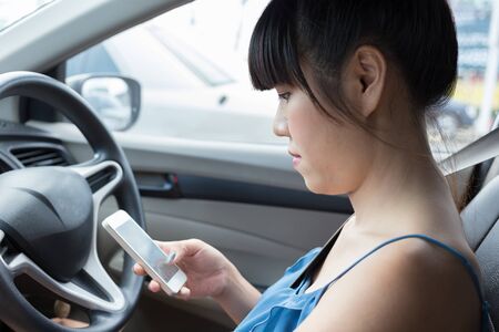 woman driver using a smart phone in car