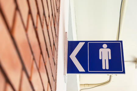 restroom signs with male symbol and arrow direction signsの写真素材