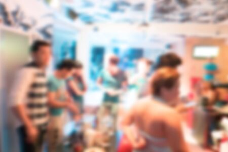 image blurred background, group of young people having joyful dancing in nightclub partyの写真素材