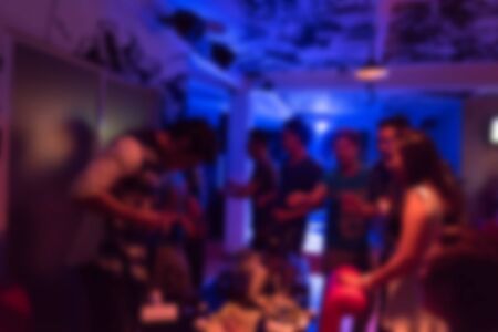 image blurred background, group of young people having joyful dancing in nightclub partyの写真素材