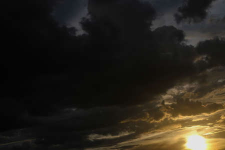 black cloud on sunset dramatic dark sky backgroundの写真素材