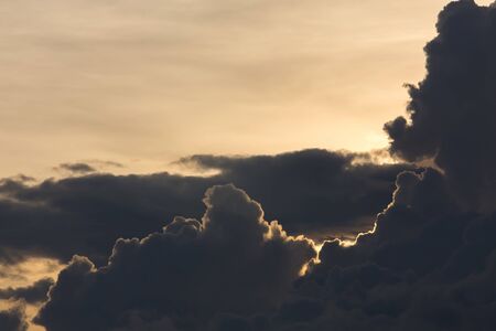 beautiful sunset sky, dramatic moody sky, black cloudy on yellow light sky backgroundの写真素材
