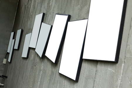 blank photo frame hanging on cement wall interior room