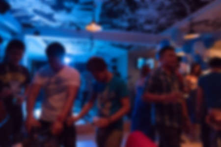 image blurred background, group of young people having joyful dancing in nightclub party