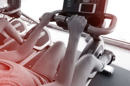 woman exercise riding bicycle in fitness center, activity of healthy care