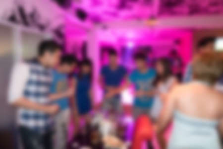image blurred background, group of young people having joyful dancing in nightclub partyの写真素材