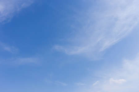 clear blue sky background with wind blowing cloudの写真素材