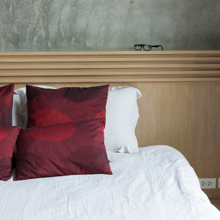 bedroom interior design modern style with white mattress and red pillow and wooden headboard