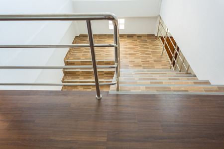 staircase in residential house with stainless steel banister, ceramic floor tiles wood patternのeditorial素材