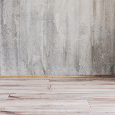 cement mortar wall background and wood floor in the roomの写真素材