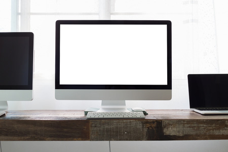 computer on wooden table work business office, white blank display screen monitorの写真素材