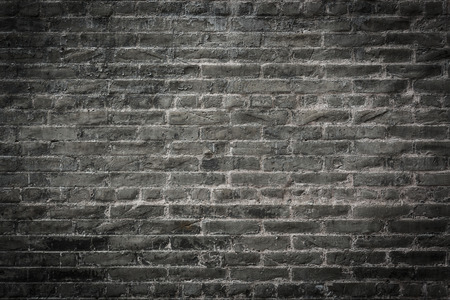 dark brick wall, black and gray brick weathered texture backgroundの写真素材