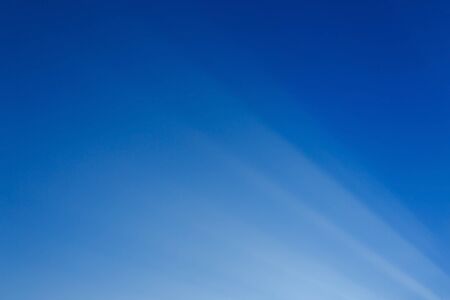 abstract white light on blue background, beam of sunlight on clear blue sky
