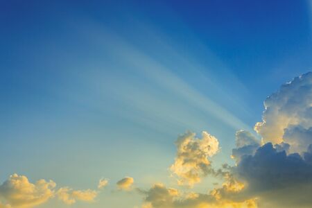 beautiful light of sunbeams, light rays on dramatic sunset sky background