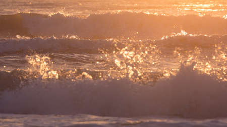 landscape of summer sea, sea surf splashing wave with sunlight in the morning dayの写真素材