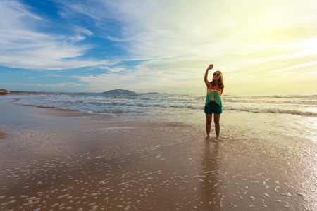 woman travel enjoy take a photo selfie on the beach with sunrise beautyful sky, travel summer backgroundの写真素材