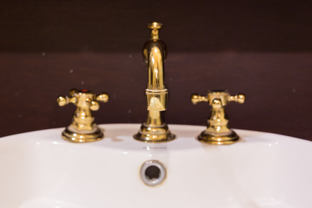 gold faucet and washbasin design retro vintage decorated luxury interior bathroomの写真素材