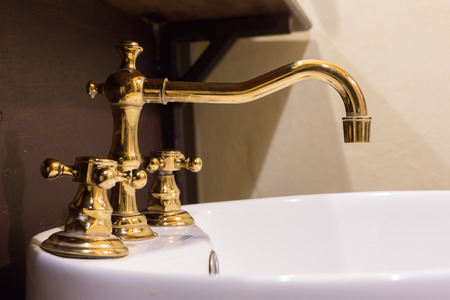 gold faucet and washbasin design retro vintage decorated luxury interior bathroomの写真素材